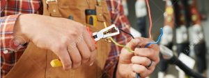 32615926-hands-of-electrician-builder-engineer-worker-with-electric-equipment-and-wire-Stock-Photo